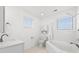 Bright bathroom featuring white tile, white cabinets, and a combined shower and bathtub at 4396 Baldwin Ave. # 19, Little River, SC 29566