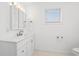 Bright bathroom with a large vanity, mirror with lighting, and tiled floors at 4396 Baldwin Ave. # 19, Little River, SC 29566