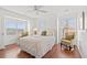 Bright bedroom featuring hardwood floors, ceiling fan and natural light from windows at 4396 Baldwin Ave. # 19, Little River, SC 29566