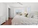 Bright bedroom featuring hardwood floors, white dresser and natural light from a large window at 4396 Baldwin Ave. # 19, Little River, SC 29566