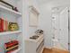 Hallway with white cabinets, wine rack, hardwood floors, and decorative shelving at 4396 Baldwin Ave. # 19, Little River, SC 29566