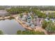 Community aerial view showcasing residences near a lake surrounded by lush trees and green space at 4413 Bed Straw Ct., Murrells Inlet, SC 29576