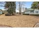 Expansive backyard with mature trees, well-maintained lawn, and a glimpse of the home's architecture at 4413 Bed Straw Ct., Murrells Inlet, SC 29576