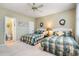 Comfortable bedroom showcasing twin beds, floral wallpaper, and an attached bathroom for added convenience at 4413 Bed Straw Ct., Murrells Inlet, SC 29576