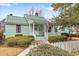 Charming home featuring a quaint front porch with an American flag and manicured landscaping at 4413 Bed Straw Ct., Murrells Inlet, SC 29576