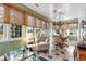 Cozy sun room with a ceiling fan, oversized windows, comfortable seating, and stylish bamboo blinds at 4413 Bed Straw Ct., Murrells Inlet, SC 29576