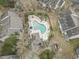 Aerial view of a community pool with lounge chairs, surrounded by well-maintained condo buildings at 4502 Little River Inn Ln. # 2507, Little River, SC 29566