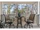 Cozy balcony seating area overlooking a peaceful wooded setting at 4502 Little River Inn Ln. # 2507, Little River, SC 29566