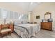 Comfortable bedroom featuring plantation shutters and a vintage dresser and desk at 4502 Little River Inn Ln. # 2507, Little River, SC 29566