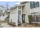 Charming condo entrance with white wood lattice and stairs leading to front door; inviting curb appeal and easy access at 4502 Little River Inn Ln. # 2507, Little River, SC 29566
