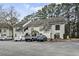 Well-maintained condo complex exterior with ample parking and mature trees, offering a comfortable and convenient living environment at 4502 Little River Inn Ln. # 2507, Little River, SC 29566