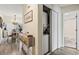 Hallway featuring a washer/dryer closet, access to bathroom, and views of dining area with hardwood floors and chandelier at 4502 Little River Inn Ln. # 2507, Little River, SC 29566