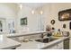 Bright kitchen featuring a breakfast bar with a marble countertop and views into the dining room with shuttered windows at 4502 Little River Inn Ln. # 2507, Little River, SC 29566