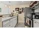 Modern kitchen featuring stainless steel appliances, custom lighting and marble countertops at 4502 Little River Inn Ln. # 2507, Little River, SC 29566