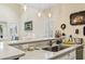 Bright kitchen with updated stainless sink, quartz countertop and modern lighting at 4502 Little River Inn Ln. # 2507, Little River, SC 29566