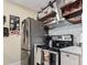 Kitchen with stainless steel refrigerator and oven, floating shelves and white countertops at 4502 Little River Inn Ln. # 2507, Little River, SC 29566