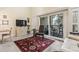 Cozy living room with a patterned rug, leather chair, and sliding glass doors to a balcony at 4502 Little River Inn Ln. # 2507, Little River, SC 29566