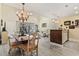Open-concept living area with hardwood floors, dining table, breakfast bar, and access to a balcony at 4502 Little River Inn Ln. # 2507, Little River, SC 29566