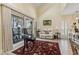Bright living room with a love seat, sliding glass doors to a balcony, and an area rug at 4502 Little River Inn Ln. # 2507, Little River, SC 29566