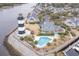 Aerial view showcases the community pool next to a charming lighthouse and the serene waterway at 4515 Lighthouse Dr. # 25B, Little River, SC 29566