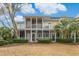 Rear exterior view of townhome featuring screened in patios with decorative lighting on both floors at 4515 Lighthouse Dr. # 25B, Little River, SC 29566