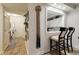 Hallway view into kitchen with bar seating, decor and wood-look flooring at 4515 Lighthouse Dr. # 25B, Little River, SC 29566