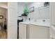 A well-lit laundry room with a white washer and dryer set and wire shelving at 4515 Lighthouse Dr. # 25B, Little River, SC 29566