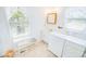 Bathroom with a laundry area, vanity, and a window offering natural light at 4601 Lewis St., North Myrtle Beach, SC 29582