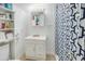 Well-lit bathroom with a vanity, mirror, and stylish shower curtain creating a refreshing space at 4601 Lewis St., North Myrtle Beach, SC 29582