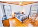 Bedroom with hardwood floors, a rocking chair, and a classic-style bed with a patterned comforter at 4601 Lewis St., North Myrtle Beach, SC 29582