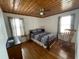 Bedroom with a queen size bed, rocking chair, wood-look flooring and wooden ceiling at 4601 Lewis St., North Myrtle Beach, SC 29582