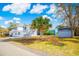 Charming two-story home with blue shutters and a lush green lawn featuring a palm tree at 4601 Lewis St., North Myrtle Beach, SC 29582