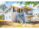 Charming two-story home with a screened porch and blue shutters at 4601 Lewis St., North Myrtle Beach, SC 29582