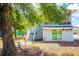 Home with a screened porch and sliding glass doors with mature shade trees at 4601 Lewis St., North Myrtle Beach, SC 29582