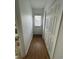 Hallway with hardwood flooring, white walls, and a closet for storage at 4601 Lewis St., North Myrtle Beach, SC 29582