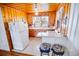 Bright kitchen with white appliances, wooden cabinets, and cozy seating at the counter at 4601 Lewis St., North Myrtle Beach, SC 29582