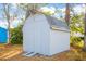 Close up view of a backyard storage shed with double doors, adding functionality to the property at 4601 Lewis St., North Myrtle Beach, SC 29582