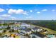 Aerial view of a vibrant community showcasing lush landscaping, a pool, and serene surroundings near nature trails at 4872 Dahlia Ct. # 202, Myrtle Beach, SC 29577