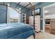 Well-lit bedroom showcasing a four poster bed, dresser with television, and a large window at 4872 Dahlia Ct. # 202, Myrtle Beach, SC 29577