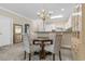 Dining room area featuring modern glass table and chandelier at 4872 Dahlia Ct. # 202, Myrtle Beach, SC 29577