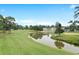 Scenic view of the golf course, pond, and community buildings at 4872 Dahlia Ct. # 202, Myrtle Beach, SC 29577