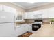 Bright kitchen featuring all-white appliances, cabinets, and countertops at 4872 Dahlia Ct. # 202, Myrtle Beach, SC 29577