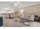 Cozy living room featuring neutral tones, plush sofa, and a modern rug, adjacent to dining area at 4872 Dahlia Ct. # 202, Myrtle Beach, SC 29577