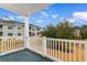 Outdoor patio featuring white railings overlooking a green landscape and building views at 4872 Dahlia Ct. # 202, Myrtle Beach, SC 29577