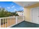 Outdoor patio featuring yellow siding, a white railing, and neighborhood views at 4872 Dahlia Ct. # 202, Myrtle Beach, SC 29577