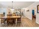 Open-concept dining room with wood floors that flow into the kitchen and living area at 4882 Luster Leaf Circle # 305, Myrtle Beach, SC 29577