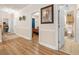 Hallway with wood floors leads to bedrooms and bathroom with tile floors at 4882 Luster Leaf Circle # 305, Myrtle Beach, SC 29577