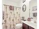 Cozy bathroom featuring a vanity with a white sink, a brown cabinet, and a palm tree shower curtain at 4905 Britewater Ct. # 202, Myrtle Beach, SC 29579