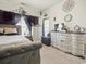 Bedroom features an accent wall, dresser, and a large window that provides natural light at 4905 Britewater Ct. # 202, Myrtle Beach, SC 29579