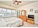 Bedroom with a ceiling fan, large windows, and a wooden dresser with a mirror at 4905 Britewater Ct. # 202, Myrtle Beach, SC 29579